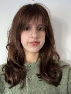Young woman with long brown hair and a full fringe